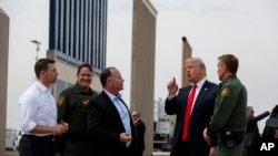 President Donald Trump reviews border wall prototypes, March 13, 2018, in San Diego.