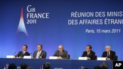 French Foreign Minister Alain Juppe, center, addresses reporters during a joint press conference held at the end of the G8 Foreign Ministers meeting in Paris, March 15, 2011
