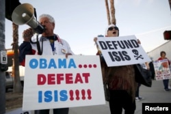 FILE - Raul Rodriguez Jr., left, of America First Latinos protests against the Islamic State group ahead of President Barack Obama's visit with the families of shooting victims in San Bernardino, California, Dec. 18, 2015.