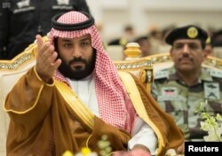 Saudi Crown Prince Mohammed bin Salman gestures during a military parade by Saudi security forces in preparation for the annual Haj pilgrimage in the holy city of Mecca, Saudi Arabia, Aug. 23, 2017.