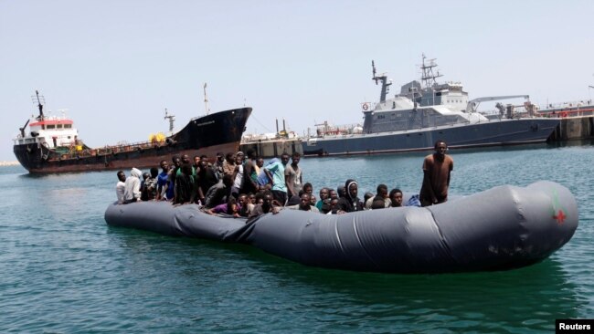 FILE - Illegal migrants arrive in a dinghy at a naval base after they were rescued by Libyan Coast Guard in the coastal city of Tripoli, Libya, May 6, 2017. 