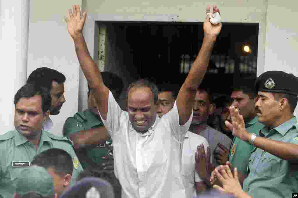 A border guard who was acquitted reacts as he leaves a special court in Dhaka, Nov. 5, 2013.