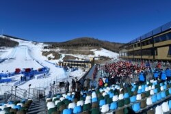 Spectators watch the competition during the FIS Ski Cross World Cup 2022, part of a 2022 Beijing Winter Olympic Games test event at Genting Snow Park in Chongli county, Zhangjiakou city, China's Hebei province, Nov. 27, 2021.