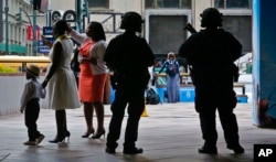 FILE - Members of a New York Police Department anti-terror unit guard an entry area to Madison Square Garden as families arrive for a graduation ceremony, May 23, 2017, in New York City.