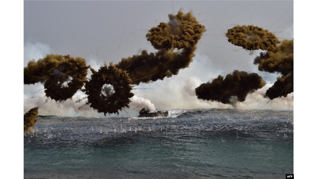 FILE - South Korean Marine amphibious assault vehicles fire smoke shells to land on the seashore during a joint landing operation by US and South Korean Marines in the southeastern port of Pohang, March 30, 2015.