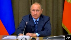FILE - Russian President Vladimir Putin heads a meeting with senior military officials at the Black Sea resort of Sochi, Russia, Nov. 16, 2016. 