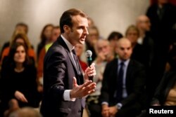 FILE - French President Emmanuel Macron attends a meeting with local residents as part of the "Great National Debate" in Bourg-de-Peage near Valence, France, Jan. 24, 2019.