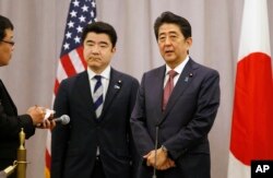 Japanese Prime Minister Shinzo Abe, right, speaks to members of the press after meeting with President-elect Donald Trump, Nov. 17, 2016.