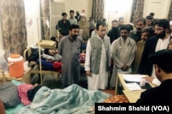 Khyber Pakhtunkhwa Minister for Education Muhammad Atif Khan inquires about injured patients at the DHQ hospital in Mardan, Pakistan, Oct. 27, 2015.