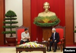 Philippines President Rodrigo Duterte, left, and Vietnam's Communist Party General Secretary Nguyen Phu Trongt talk at the party's headquarters in Hanoi, Vietnam, September 29, 2016.