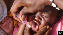 FILE - A Sudanese child is immunized against measles in North Darfur, Sudan.