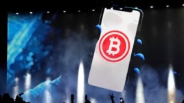 A bitcoin symbol is presented on an LED screen during the closing ceremony of a congress for cryptocurrency investors in Santa Maria Mizata, El Salvador, Saturday, Nov. 20, 2021. (AP Photo/Salvador Melendez)