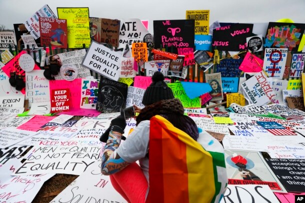 Protesters build a wall of signs outside the White House for the Women's March on Washington during the first full day of Donald Trump's presidency, Jan. 21, 2017.