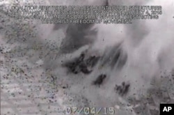 This image made from gun-camera video taken on July 4, 2015 and released by United States Central Command shows an airstrike on a bridge near Islamic State group-held Raqqa, Syria, that was a key transit route for the militants.