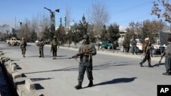 FILE - Security personnel arrive outside the site of a suicide attack in Kabul, Afghanistan, Dec. 28, 2017. 