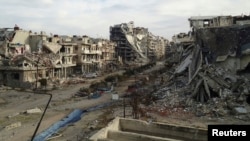 Damaged buildings and debris are pictured in the besieged area of Homs, Syria, Dec. 24, 2013. 