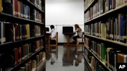 FILE - Students are seen studying in a library on the campus of California State University in Long Beach, California, Oct. 19, 2012.