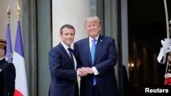 French President Emmanuel Macron greets U.S. President Donald Trump 