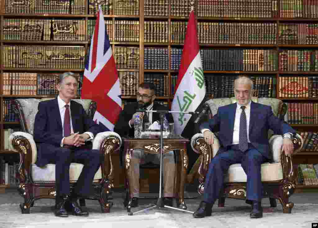 Britain&#39;s Foreign Secretary Philip Hammond, left, in a meeting with his Iraqi counterpart Ibrahim al-Jaafari, in Baghdad, Iraq, Monday, Oct. 13, 2014. Hammond said coalition airstrikes will not be enough to defeat the Islamic State group, though he also ruled out the use of foreign ground forces. 