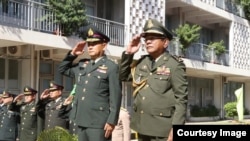 General Thanchaiyan Srisuwa, chief of defense forces of the Royal Thai Armed Forces, left, and General Pol Saroeun, commander-in-chief of the Royal Cambodian Armed Forces, right, are pictured saluting in Phnom Penh, Cambodia, June 22, 2018. (Courtesy of Gen. Pol Saroeun's Facebook page)