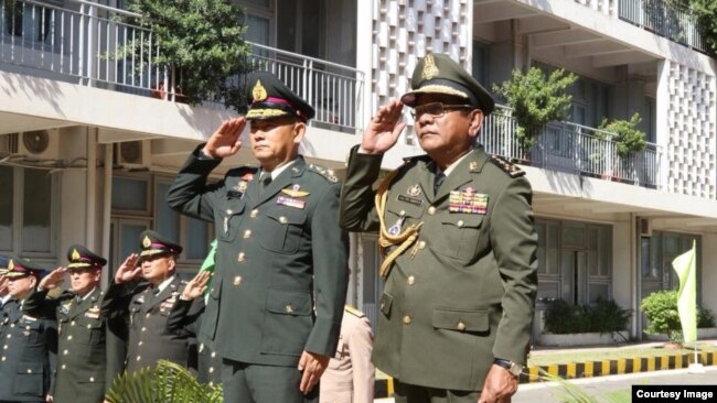 General Thanchaiyan Srisuwa, chief of defense forces of the Royal Thai Armed Forces, left, and General Pol Saroeun, commander-in-chief of the Royal Cambodian Armed Forces, right, are pictured saluting in Phnom Penh, Cambodia, June 22, 2018. (Courtesy of Gen. Pol Saroeun's Facebook page)