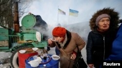 A local resident eats a meal at an emergency center after shelling hit supply infrastructure in the government-held industrial town of Avdiivka, Ukraine, Feb. 1, 2017.