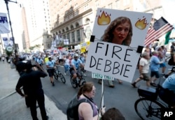 FILE - A supporters of Sen. Bernie Sanders, I-Vt., holds up a sign call calling for Debbie Wasserman Schultz, chairwoman of the Democratic National Committee to be fired, Sunday, July 24, 2016, in Philadelphia.