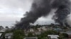 Smoke rises above buildings after days of unrest in Honiara, Solomon Islands, Nov. 25, 2021 in this still image obtained from a video recorded with a drone on Nov. 25, 2021 and obtained Nov. 27, 2021.