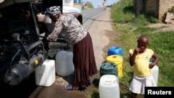 Residents of Ntuzuma collect water from a truck after cuts in water supply were made due to persistent drought conditions, in Durban, South Africa, Jan. 22, 2017.