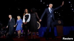 President Barack Obama (R) is joined onstage by first lady Michelle Obama and daughter Malia, Vice President Joe Biden and his wife Jill Biden, after his farewell address in Chicago, Illinois, Jan. 10, 2017. 