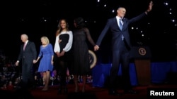 President Barack Obama (R) is joined onstage by first lady Michelle Obama and daughter Malia, Vice President Joe Biden and his wife Jill Biden, after his farewell address in Chicago, Illinois, Jan. 10, 2017. 