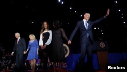 FILE - President Barack Obama (R) is joined onstage by first lady Michelle Obama and daughter Malia, Vice President Joe Biden and his wife Jill Biden, after his farewell address in Chicago, Illinois, Jan. 10, 2017. 