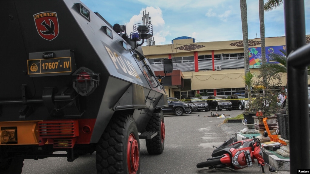 FILE - A security vehicle is seen following an attack at the entrance of a police station in Pekanbaru, Indonesia, May 16, 2018.