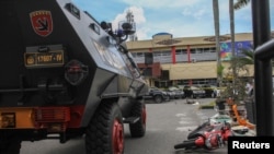 FILE - A security vehicle is seen following an attack at the entrance of a police station in Pekanbaru, Indonesia, May 16, 2018.
