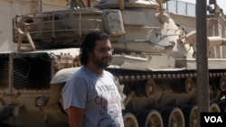 Egyptian pro-democracy activist Alla Abdel-Fattah was barred from the court session where he was sentenced to 15 years in prison for protesting a restrictive protest law, Cairo, June 11, 2014. (Hamada Elrasam/VOA) 