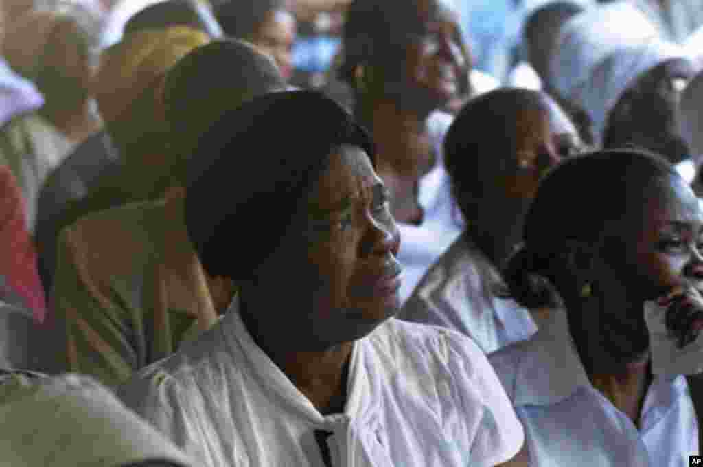 A woman reacts during a church service to commemorate the second anniversary of the 2010 earthquake in Port-au-Prince, January 12, 2012.