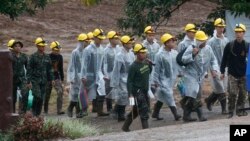 Rescuers walk toward the entrance to a cave complex in Mae Sai, Chiang Rai province, northern Thailand Tuesday, July 10, 2018. (AP Photo/Sakchai Lalit)