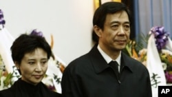 China's former Chongqing Municipality Communist Party Secretary Bo Xilai (R) and his wife Gu Kailai stand at a mourning held for his father Bo Yibo, former vice-chairman of the Central Advisory Commission of the Communist Party of China, in Beijing in thi