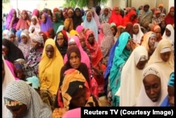 Widows registering for monthly foods supplies from the ICRC in Maiduguri, Nigeria, September 2015.