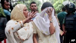 Một người thân an ủi cô Semin Rahman (đang che mặt) có con trai mất tích sau khi lực lượng an ninh giải cứu các con tin tại nhà hàng ở Dhaka, Bangladesh, ngày 2 tháng 7 năm 2016.