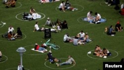 Un grupo de personas en Domino Park se ven en círculos pintados como pautas para el distanciamiento social durante el brote del coronavirus (COVID-19) en Brooklyn, Nueva York, EE. UU.,el 24 de mayo de 2020.