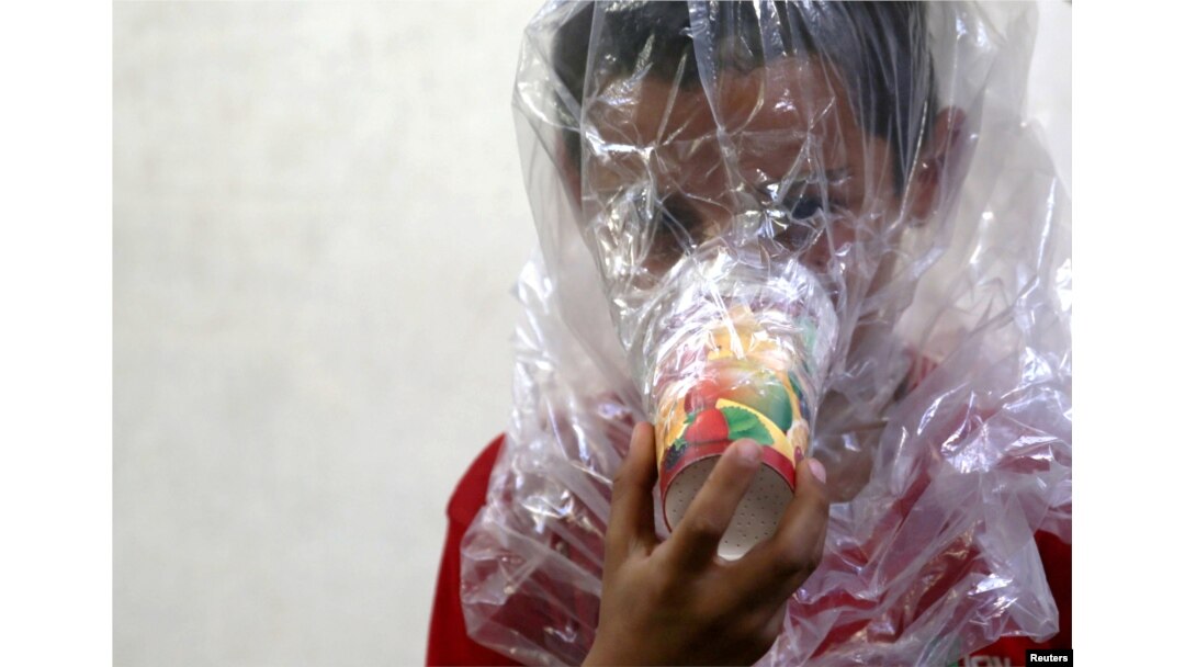 A boy tries on an improvised gas mask in Idlib, Syria, Sept. 3, 2018. The U.S. special adviser for Syria, Jim Jeffrey, said there is evidence that chemical weapons are being prepared by Syrian forces around Idlib.