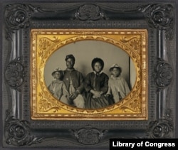 Rare photo of unidentified African American soldier in US Civil War Union uniform with wife and two daughters between 1863 and 1865. (Library of Congress)