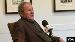 FILE - Former president George W. Bush is interviewed by VOA's Kane Farabaugh at the Bush Presidential Museum in Dallas, Texas.