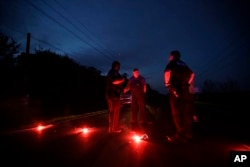 A man talks with officers at a roadblock near the Arkema Inc. chemical plant, Aug. 31, 2017, in Crosby, Texas. The plant that lost power after Harvey engulfed the area was rocked by multiple explosions early Thursday, the plant's operator said.