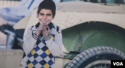 Shagofa Alikozay’s award-winning photograph of an 8-year-old boy named Pardes was taken during a break in his work washing cars on the streets of Kabul, shown in this image taken from video.