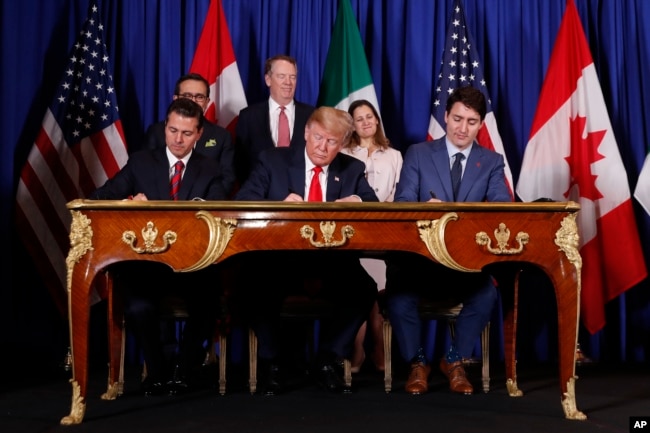 FILE - President Donald Trump, Canada's Prime Minister Justin Trudeau, right, and Mexico's then-President Enrique Pena Nieto, left, participate in the USMCA signing ceremony in Buenos Aires, Argentina, Nov. 30, 2018.