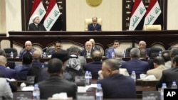 Iraqi Prime Minister Haider al-Abadi, center, attends a session of the Iraqi Parliament, in Baghdad, Iraq, Wednesday, Sept. 27, 2017. Al-Abadi on Wednesday ordered the Kurdish region to hand over control of its airports to federal authorities or face a flight ban.