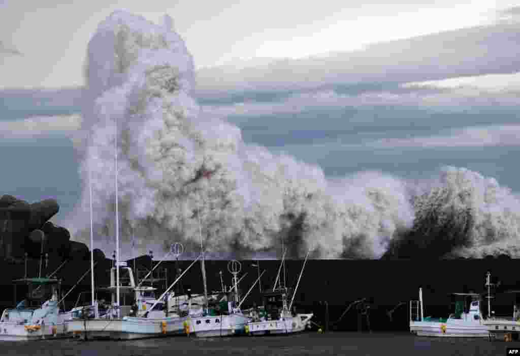 High waves hit a barrier at a port at Kihou town in Mie prefecture, central Japan. Typhoon Phanfone caused strong winds and large waves in Japan, and have already swept three U.S. military officials out to sea.