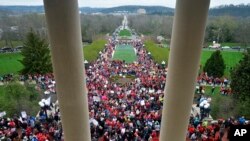 Teachers from across Kentucky gather outside the state Capitol to rally for increased funding and to protest changes to their state funded pension system, Monday, April 2, 2018, in Frankfort, Ky. (AP Photo/Timothy D. Easley)